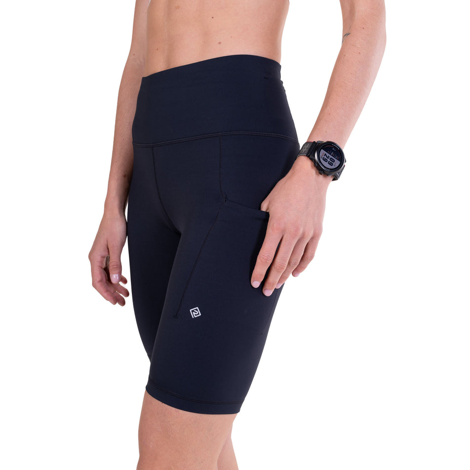 Angled view of a model wearing the Ronhill Women's Tech Contour Stretch Short in the All Black colourway.