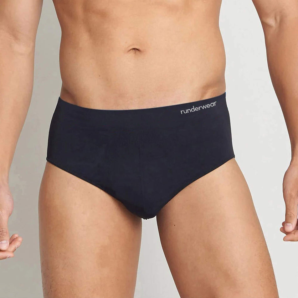 Front view of a model wearing the Runderwear Men's Running Brief in the Black colourway (8742141198498)