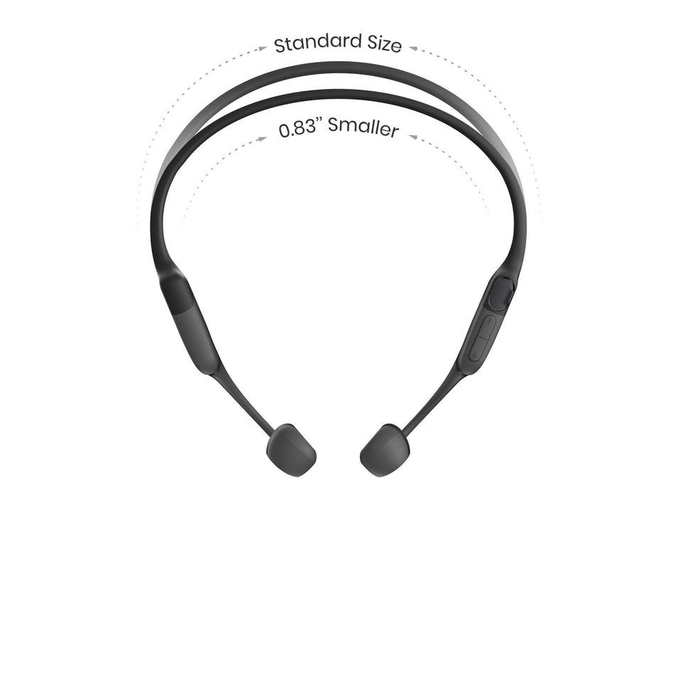 A pair of Shokz Unisex OpenRun Mini Wireless Bone Conduction Headphones in the Black colourway, along with a reference line and text to demonstrate that they are smaller than the standard size. (8541479305378)