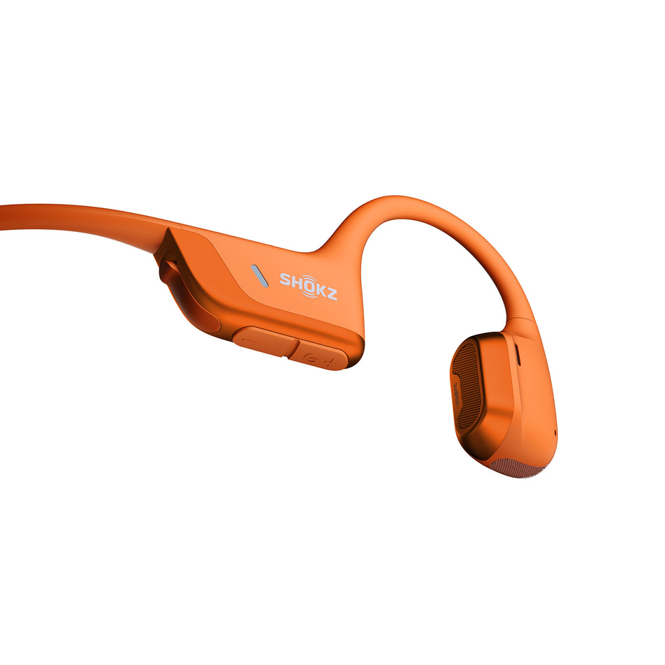 Close-up of the controls on the right earbud of pair of Shokz Unisex OpenRun Pro 2 Wireless Bone Conduction Headphones in the Orange colourway. (8541428088994)