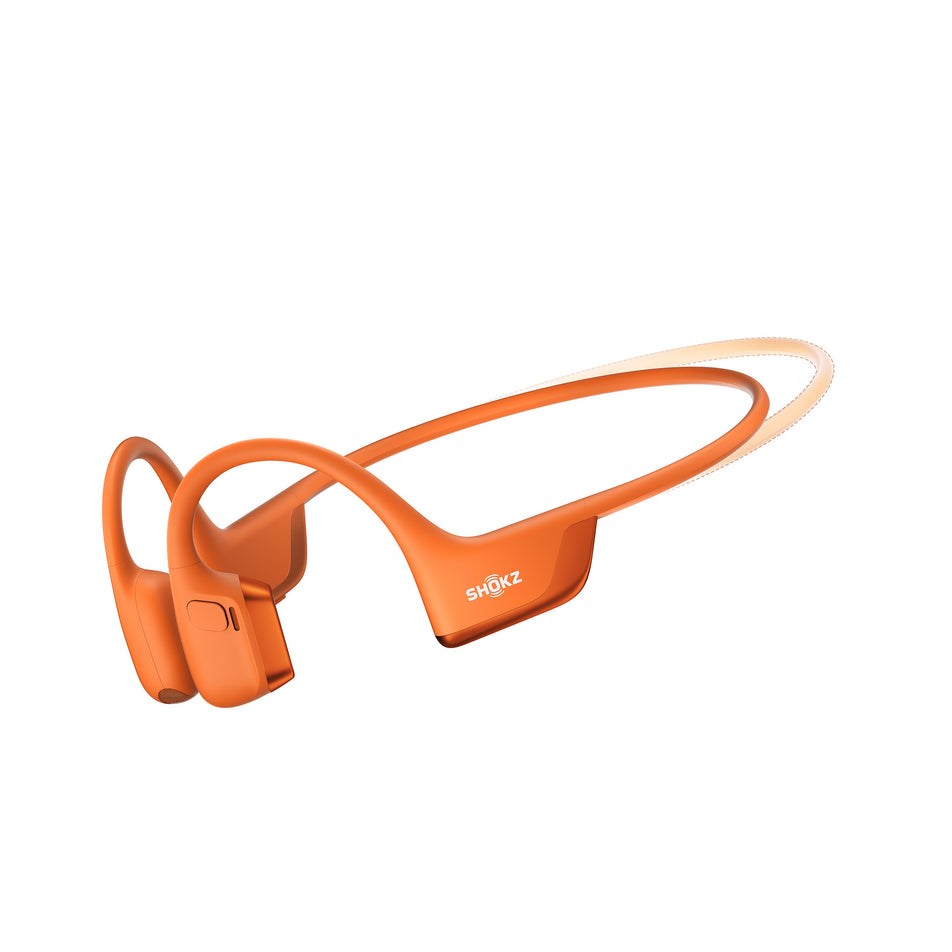 A pair of Shokz Unisex OpenRun Pro 2 Mini Wireless Bone Conduction Headphones, in the Orange colourway, against the outline of the standard size. (8541433299106)