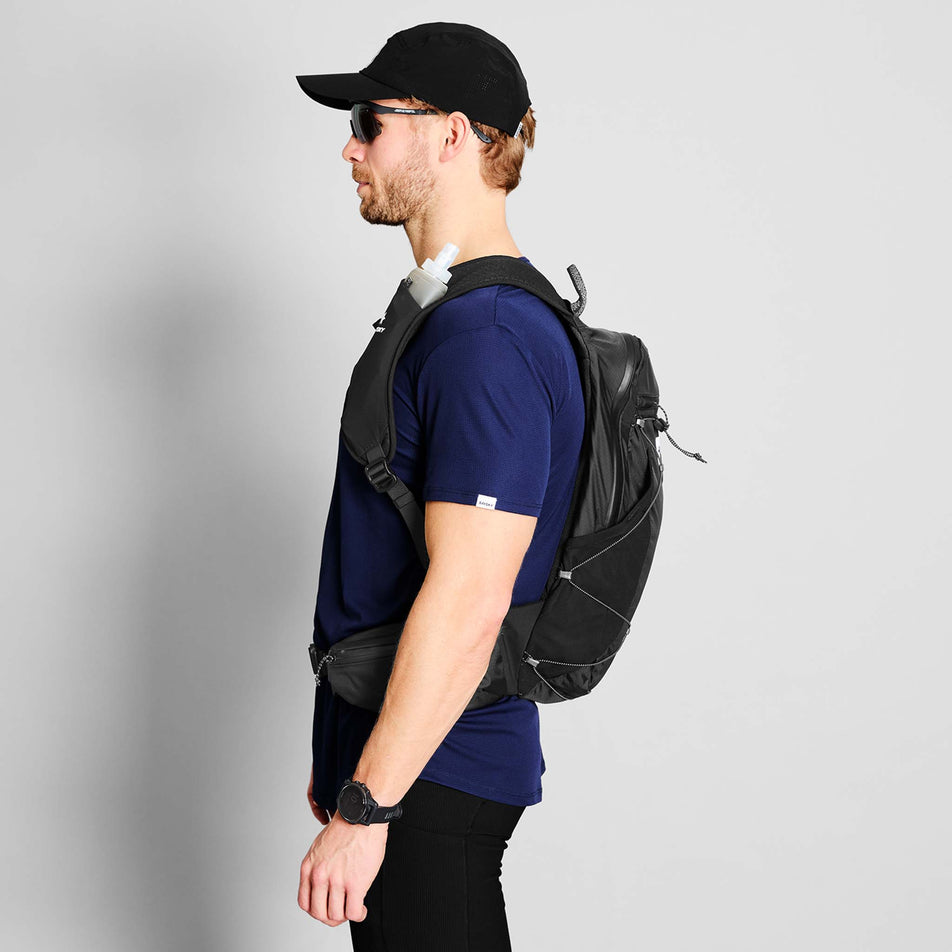 Side view of a model wearing the SAYSKY Unisex Commuter Backpack 14L in the Black colourway.