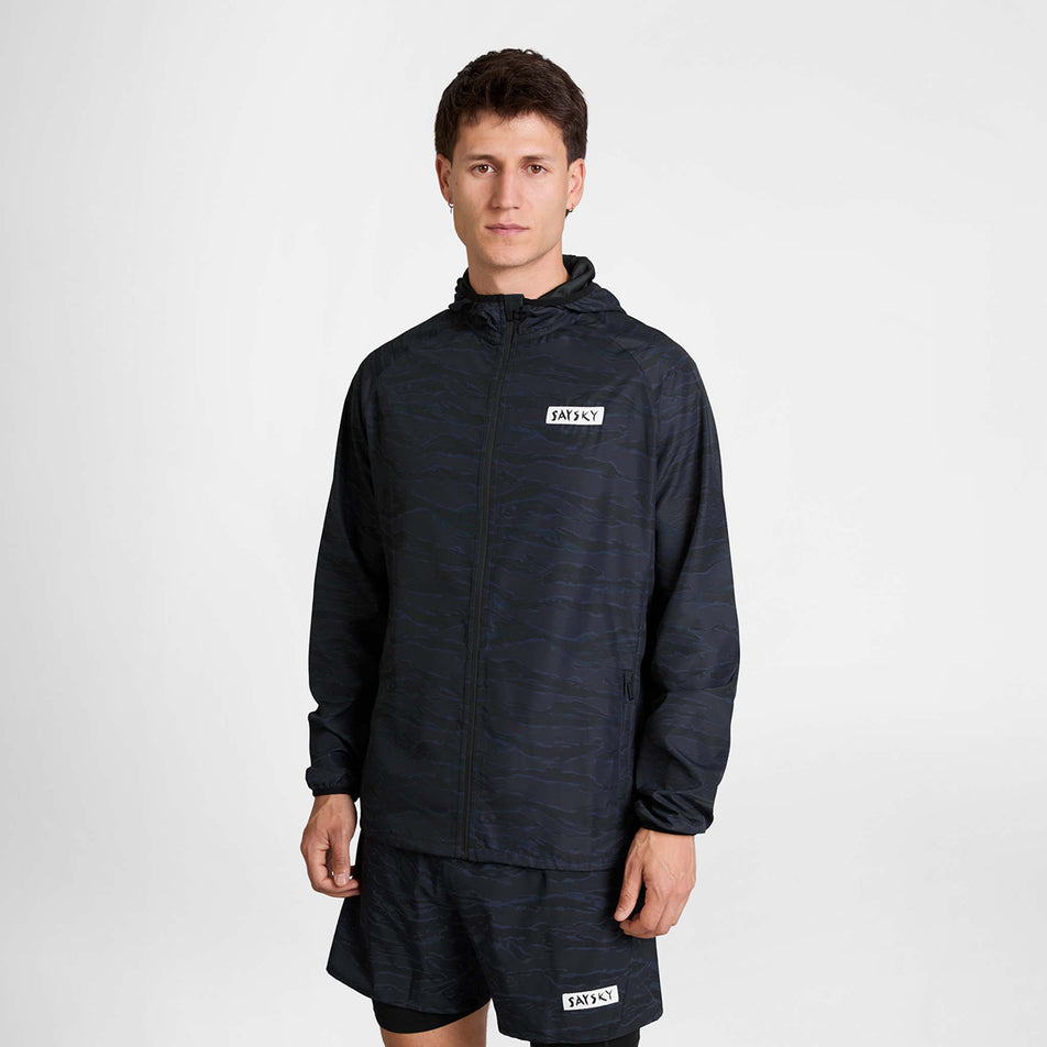 Front view of a model wearing the SAYSKY Men's Tiger Pace Jacket in the Black Camo colourway.