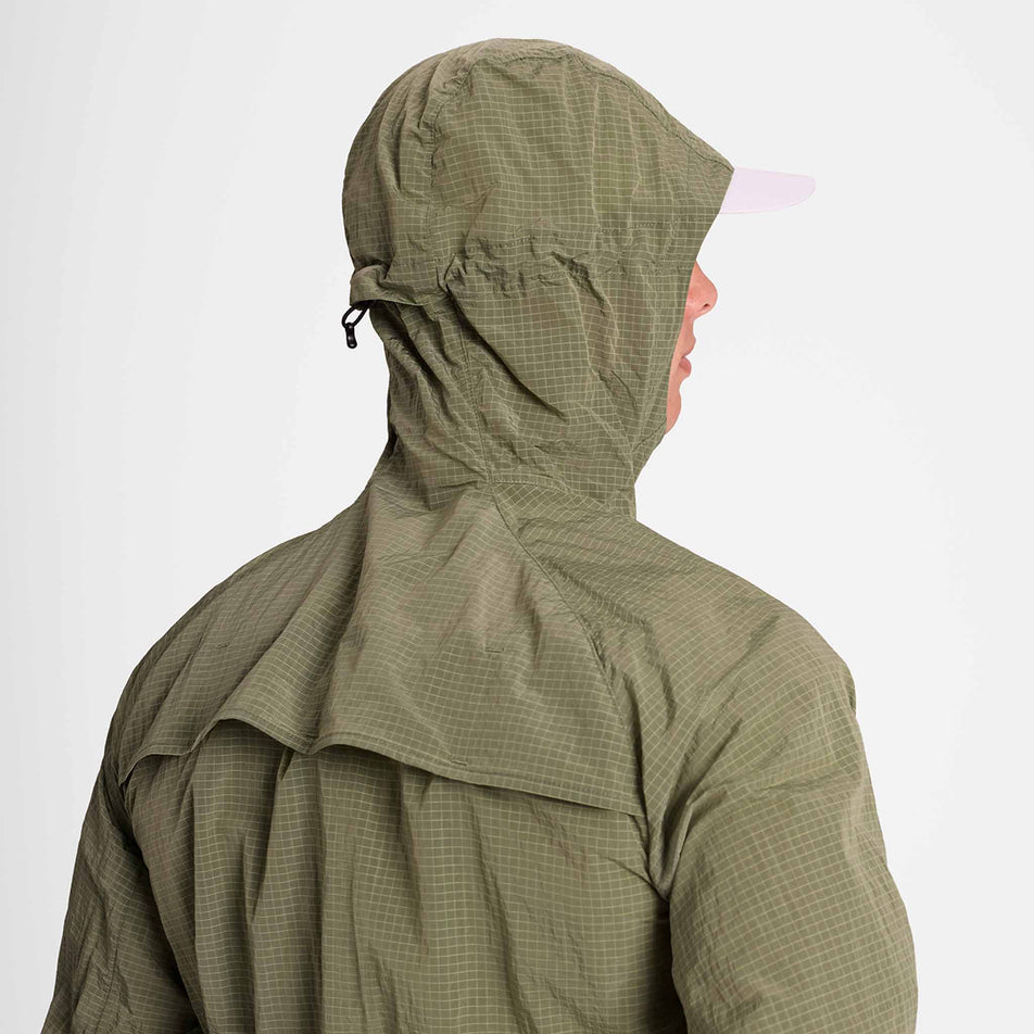 Back view of a model wearing the SAYSKY Men's Clean Pace Shield Jacket in the Beige colourway.