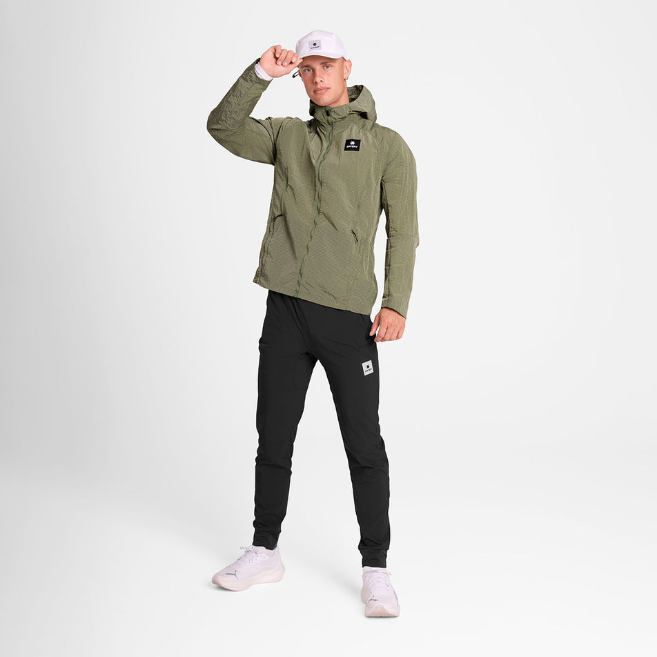 Front view of a model wearing the SAYSKY Men's Clean Pace Shield Jacket in the Beige colourway.