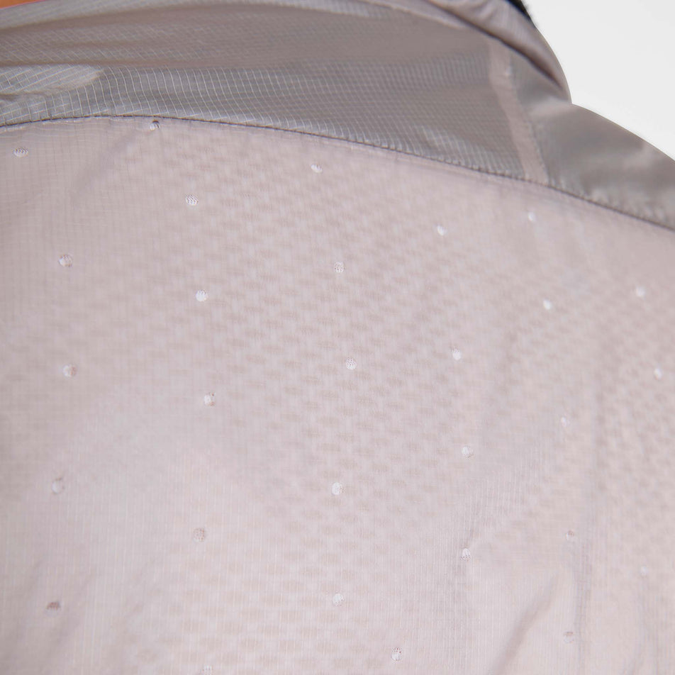 Close-up view of the back of the SAYSKY Men's Flow Thermo Jacket in the Beige colourway.