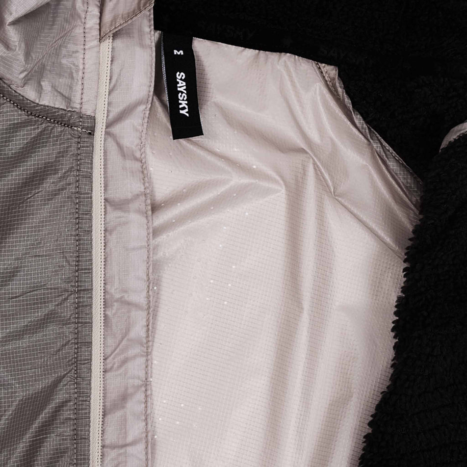 Close-up view of the inside of the SAYSKY Men's Flow Thermo Jacket in the Beige colourway.