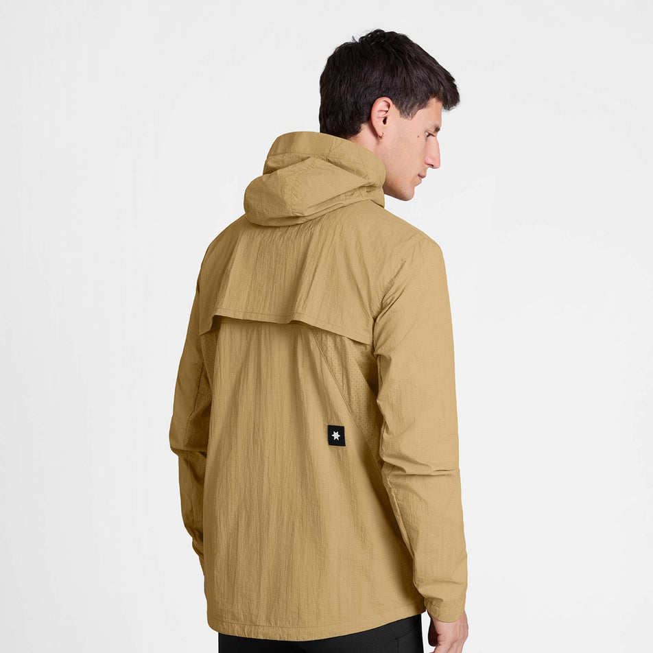 Back view of a model wearing the SAYSKY Men's Pace Tech Jacket in the Beige colourway.