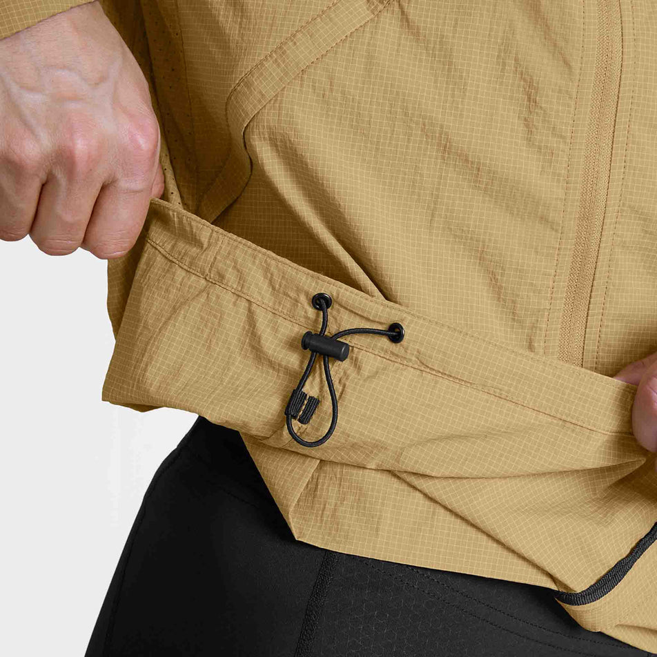 The adjustable waist cord on the SAYSKY Men's Pace Tech Jacket in the Beige colourway.