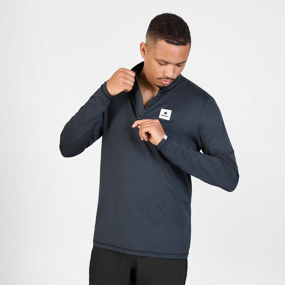 Front view of a model wearing the SAYSKY Men's Pace Half Zip Long Sleeve in the Black colourway.