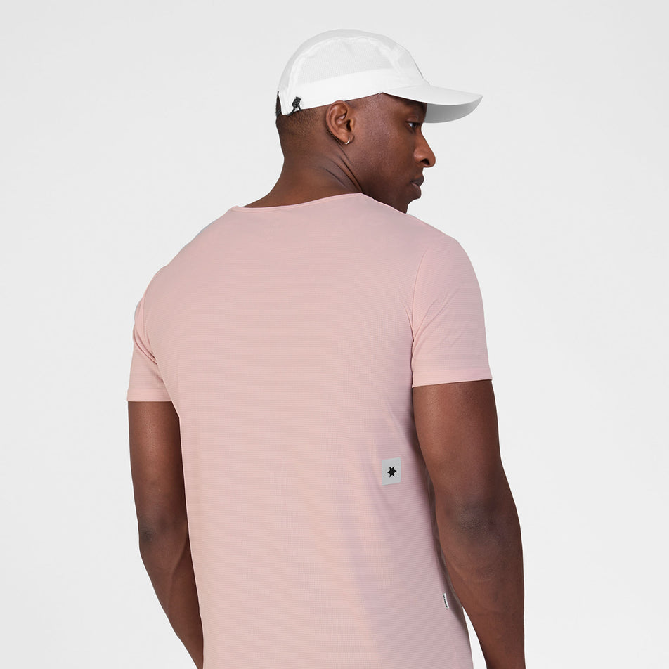Back view of a model wearing the SAYSKY Men's Reactive Flow T-Shirt in the Pink Logo colourway.