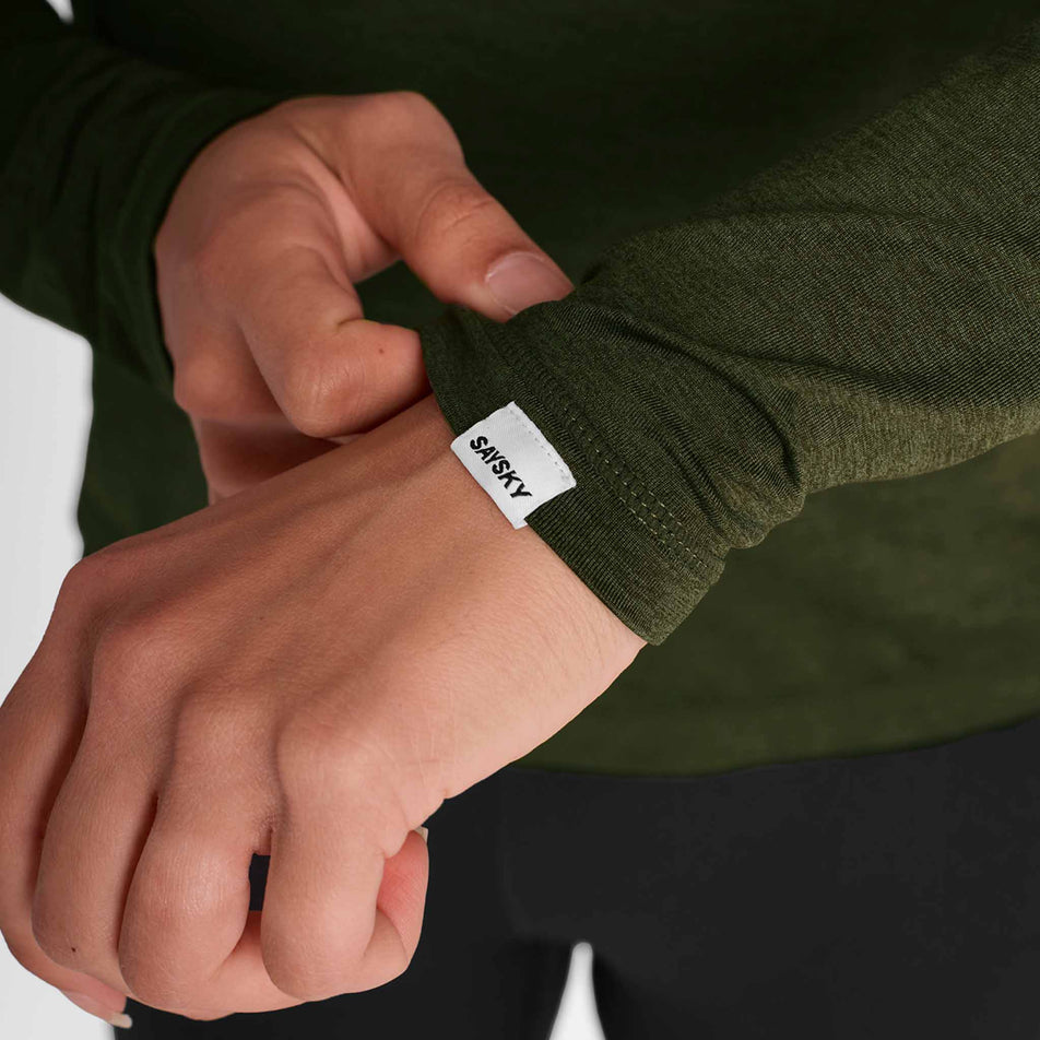 The SAYSKY logo on the sleeve of the SAYSKY Women's Pace 1/2 Zip Long Sleeve in the Green colourway.