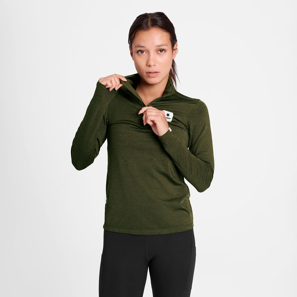 Front view of a model wearing the SAYSKY Women's Pace 1/2 Zip Long Sleeve in the Green colourway.