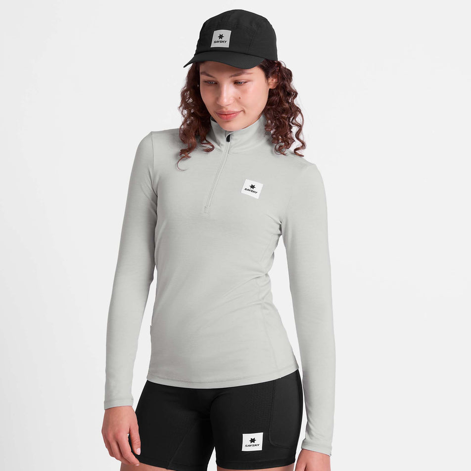 Front view of a model wearing the SAYSKY Women's Pace 1/2 Zip Long Sleeve in the Grey colourway.