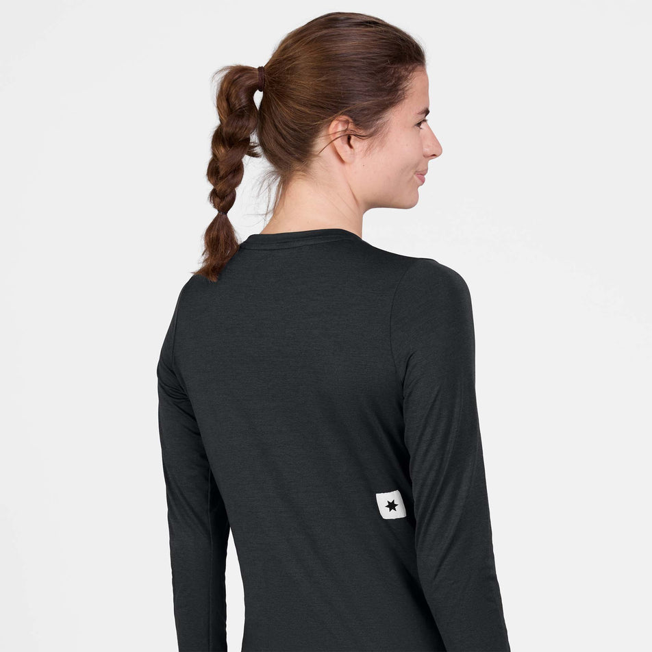 Back view of a model wearing the SAYSKY Women's Clean Pace Long Sleeve in the Black colourway.