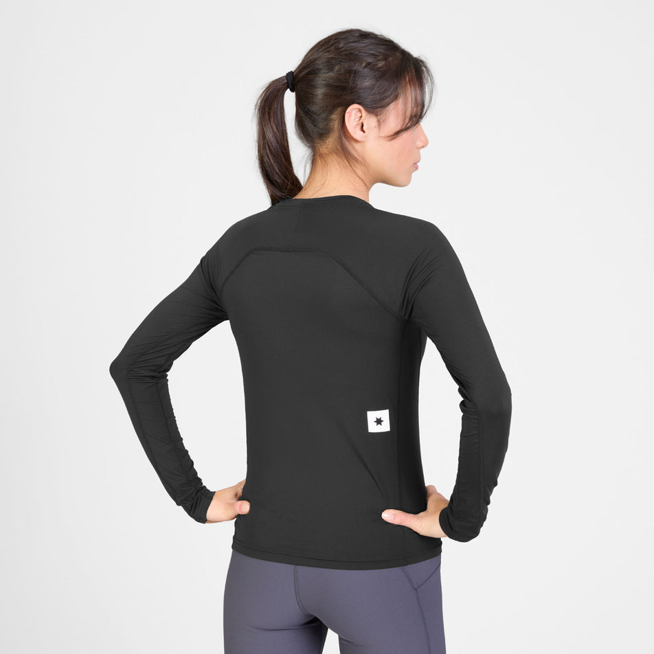 Back view of a model wearing the SAYSKY Women's Combat Tech Long Sleeve in the Black colourway.