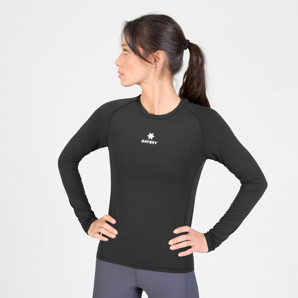 Front view of a model wearing the SAYSKY Women's Combat Tech Long Sleeve in the Black colourway.