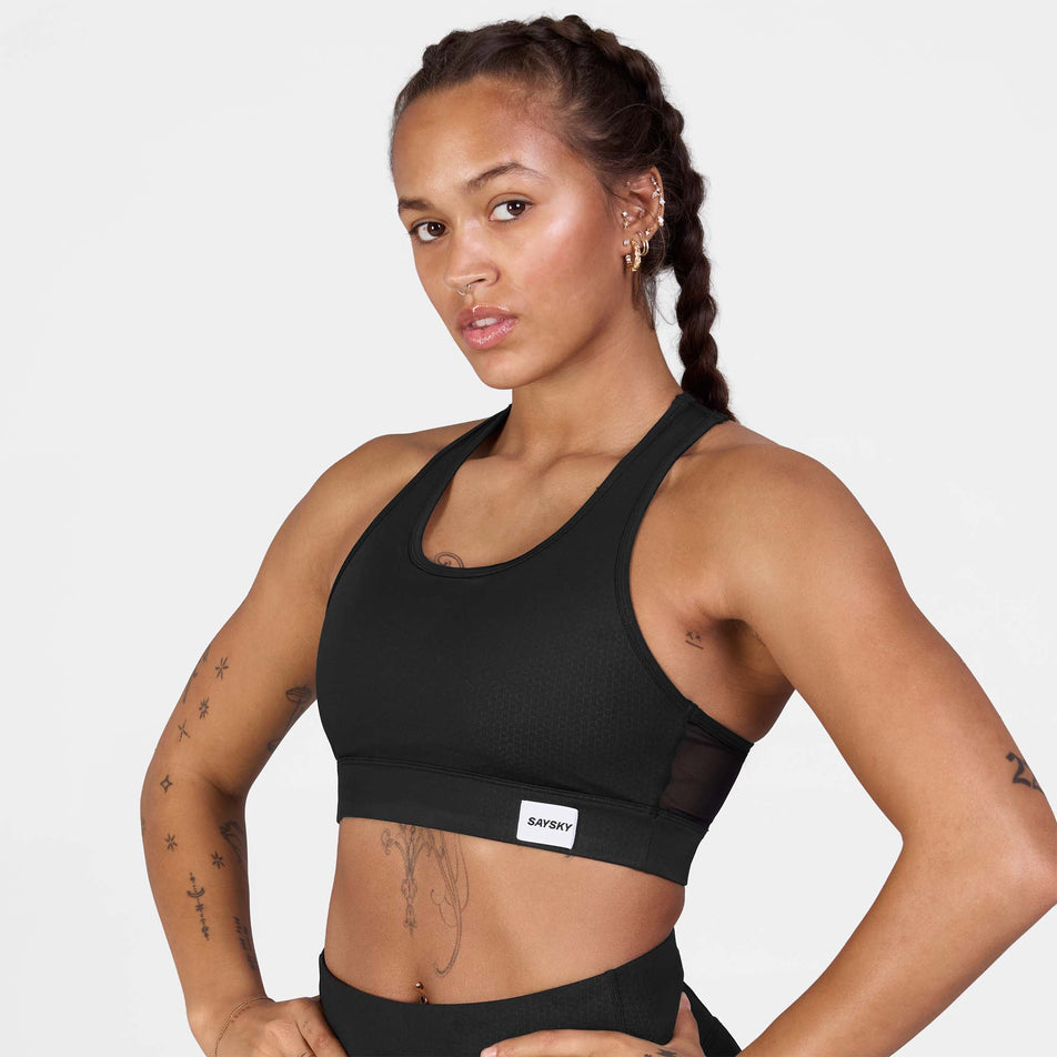 Front view of a model wearing the SAYSKY Women's Clean Combat Sports Bra in the Black colourway.