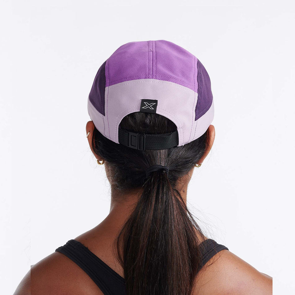 A model wearing a 2XU Unisex Light Speed Cap in the Pastel Pink/Wood Violet colourway (8149298118818)