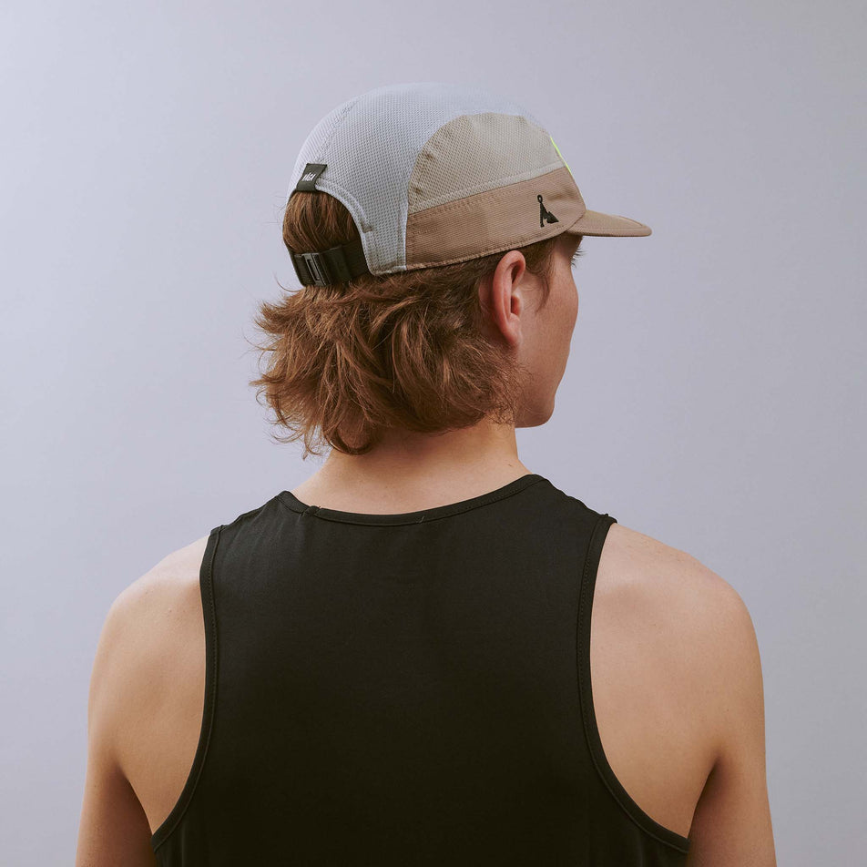 Back view of a model wearing the VÅGA Unisex Club Cap in the Taupe/Neon Yellow/Light Grey colourway.