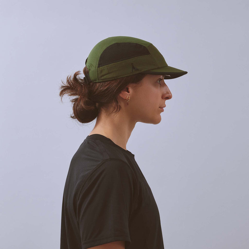 Side view of a model wearing the VAGA Unisex Club Cap in the Utility Green/Black colourway.