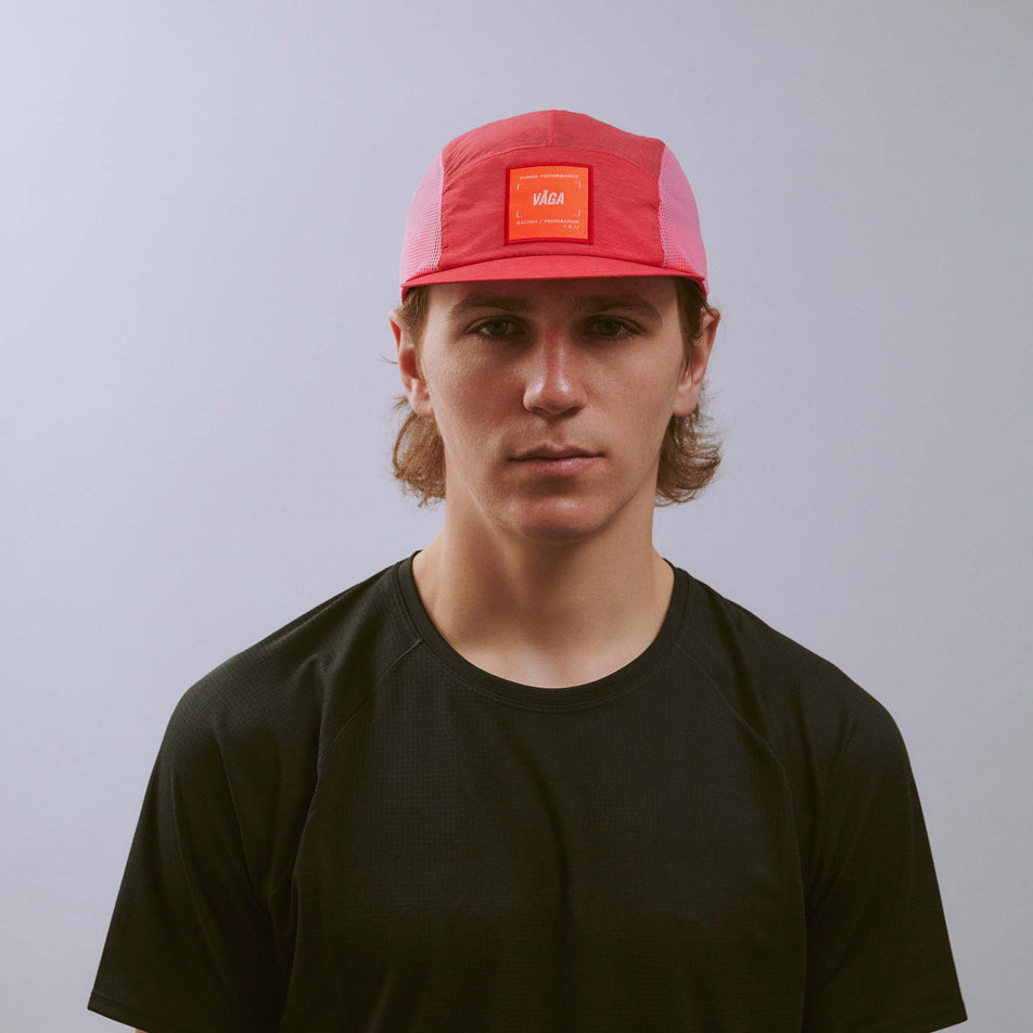 Front view of a model wearing the VÅGA Unisex Mesh Flex Cap in the Dark Pink/Pink colourway.