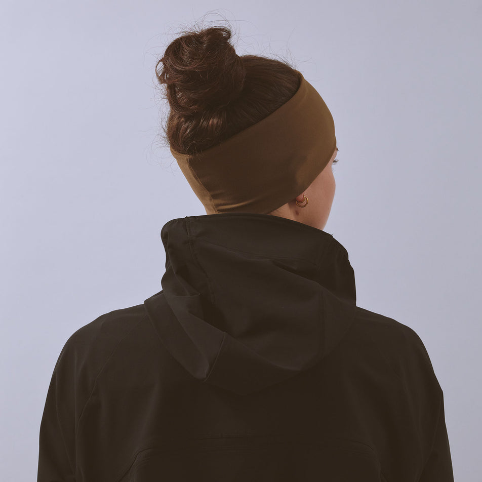 Back view of a model wearing the VAGA Unisex Jersey Midweight Headband in the Dark Taupe colourway.