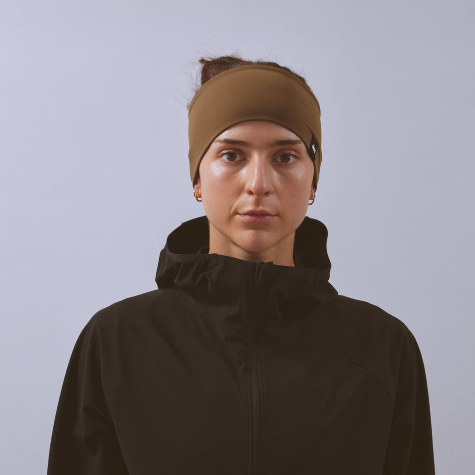 Front view of a model wearing the VAGA Unisex Jersey Midweight Headband in the Dark Taupe colourway.