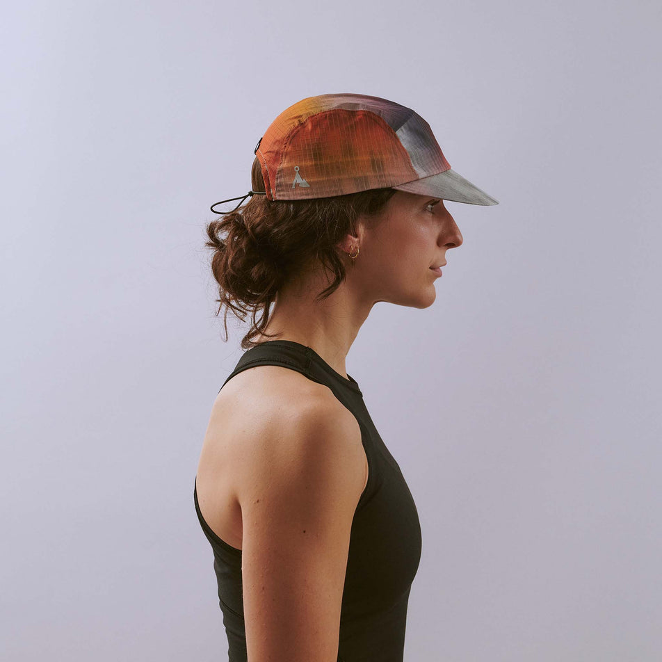 Side view of a model wearing the VÅGA Unisex Night Club Cap 2.0 in the Sunset colourway.