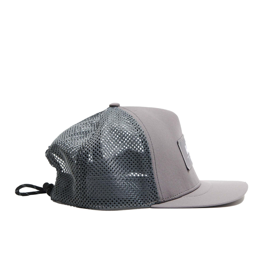 Side view of a VÅGA Unisex Open Mesh Trucker Hat in the Aluminium Grey colourway (8684639551650)