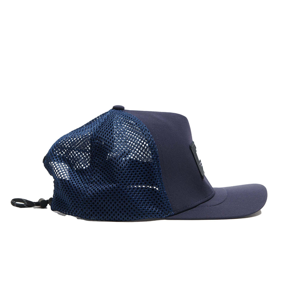 Side view of a VÅGA Unisex Open Mesh Trucker Hat in the Navy Blue colourway (8684637847714)
