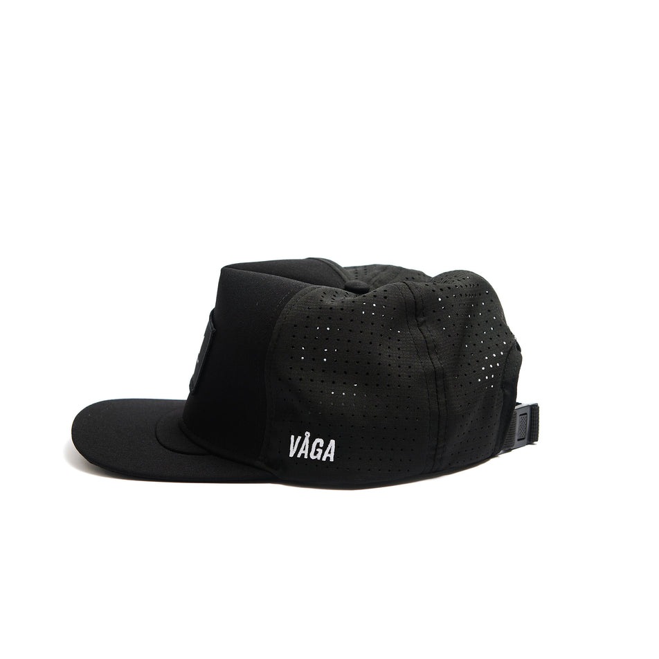 Side view of a VÅGA Unisex Trucker Cap in the Black/Charcoal Grey/White colourway. (8486987792546)