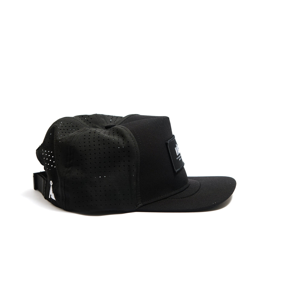 Side view of a VÅGA Unisex Trucker Cap in the Black/Charcoal Grey/White colourway. (8486987792546)