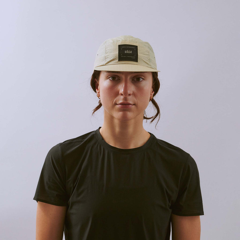 Front view of a model wearing the VÅGA Unisex Viper Lite Cap in the Taupe colourway.