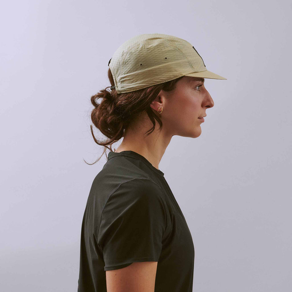 Side view of a model wearing the VÅGA Unisex Viper Lite Cap in the Taupe colourway.