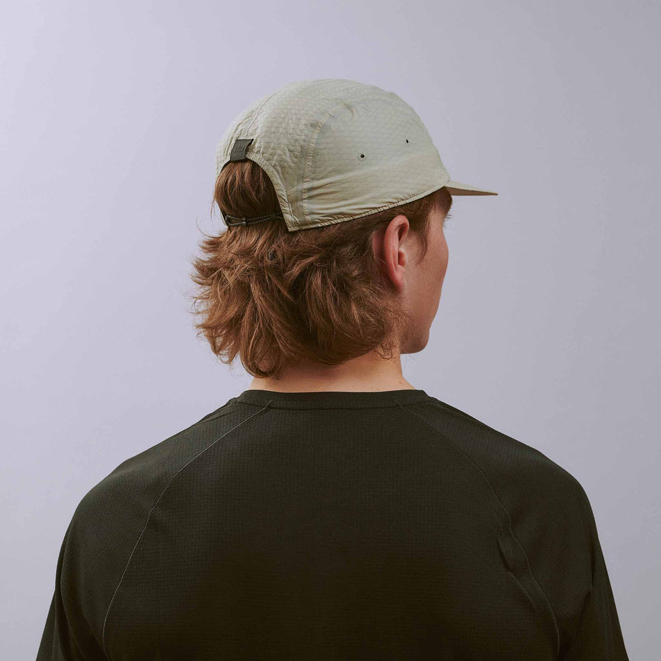 Back view of a model wearing the VÅGA Unisex Viper Lite Cap in the Taupe colourway.