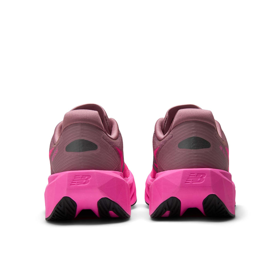 The back of a pair of New Balance Women's Fuelcell Rebel V5 Running Shoes in the Pink Heat/Rosewood colourway.