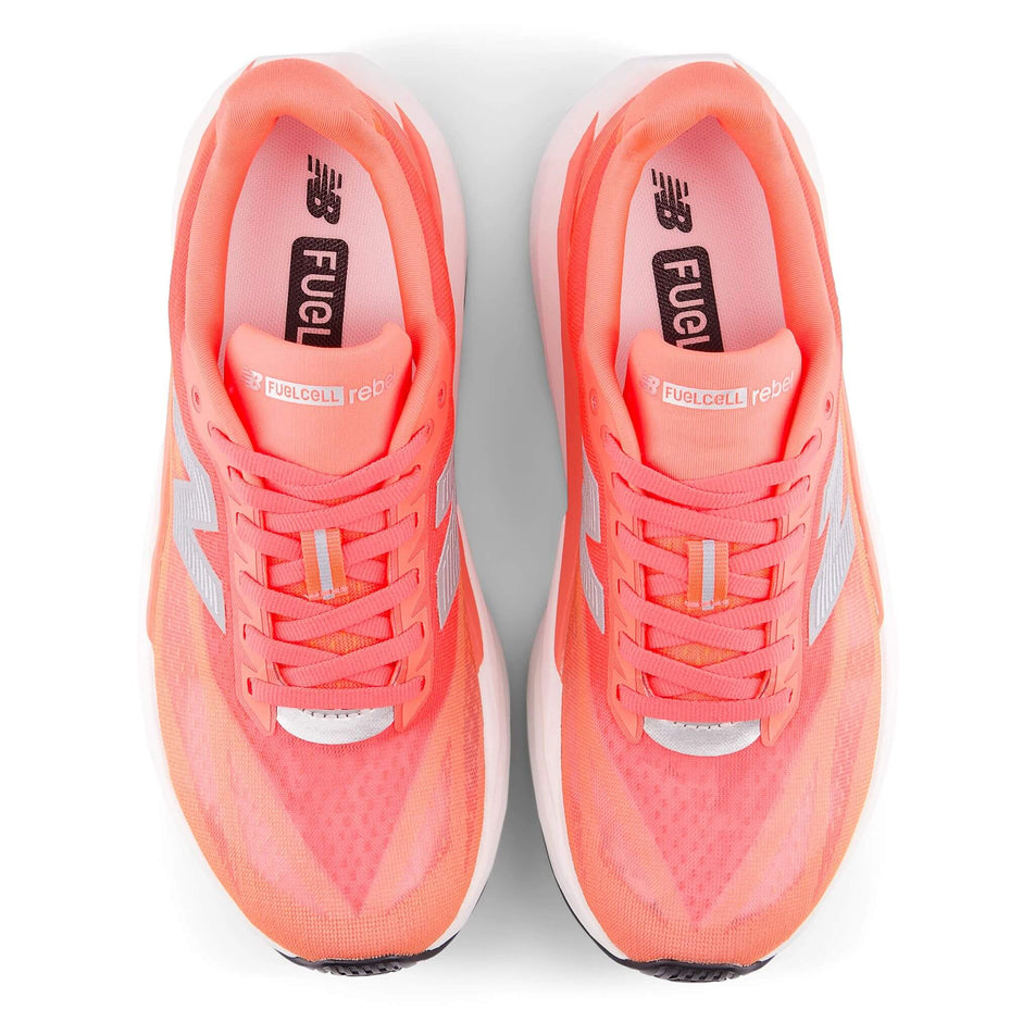 The uppers of a pair of New Balance Women's FuelCell Rebel v5 Running Shoes in the Urgent Red colourway. (8712249475234)