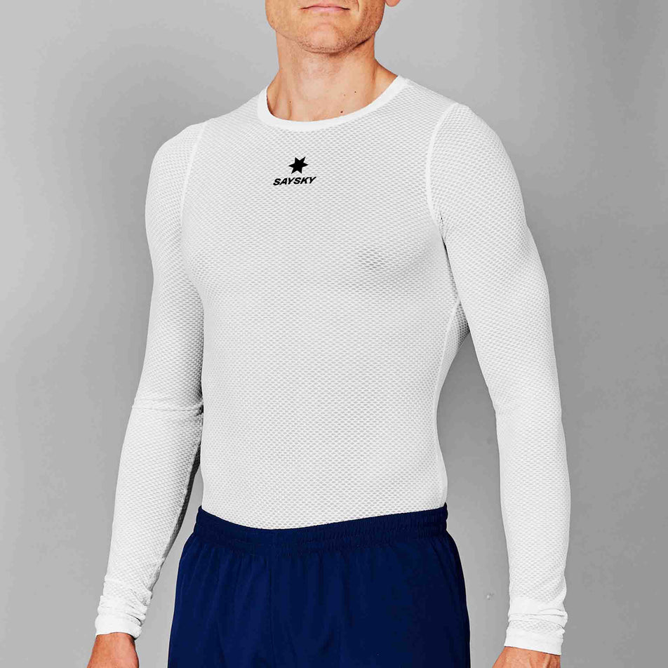 Front view of a model wearing the SAYSKY Unisex Mesh Base Layer Long Sleeve in the White colourway. Model is also wearing shorts. (8601308266658)