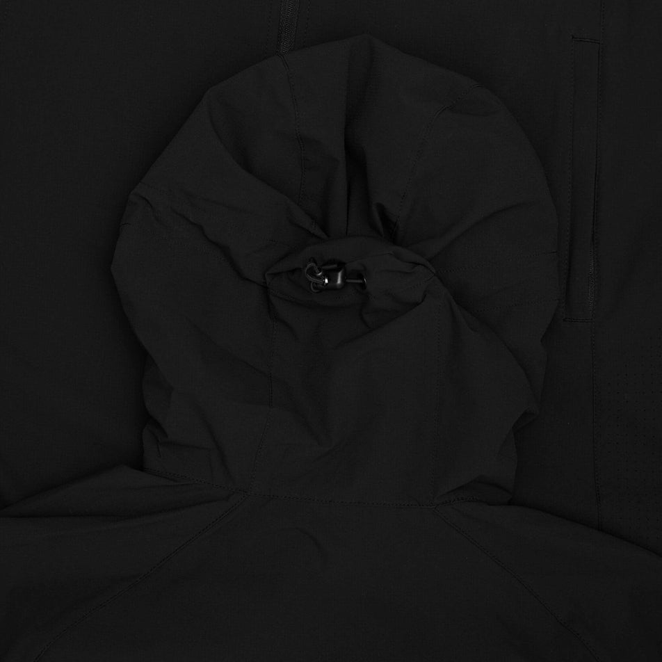 Close-up of the toggle and drawcord on the back of the hood of the SAYSKY Men's Clean Pace Flex Hooded Jacket in the Black colourway. (8601312362658)