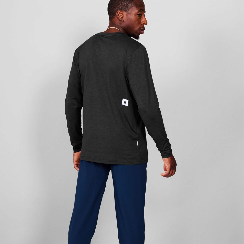 Back view of a model wearing the SAYSKY Men's Clean Pace Long Sleeve in the Black colourway. Model is also wearing tights. (8601315442850)