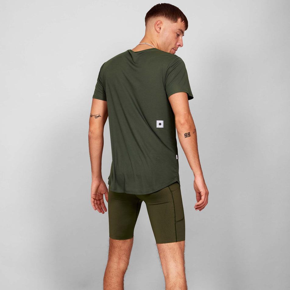 Back view of a model wearing a SAYSKY Men's Clean Flow T-Shirt in the Green colourway. Model is also wearing shorts. (8628464976034)