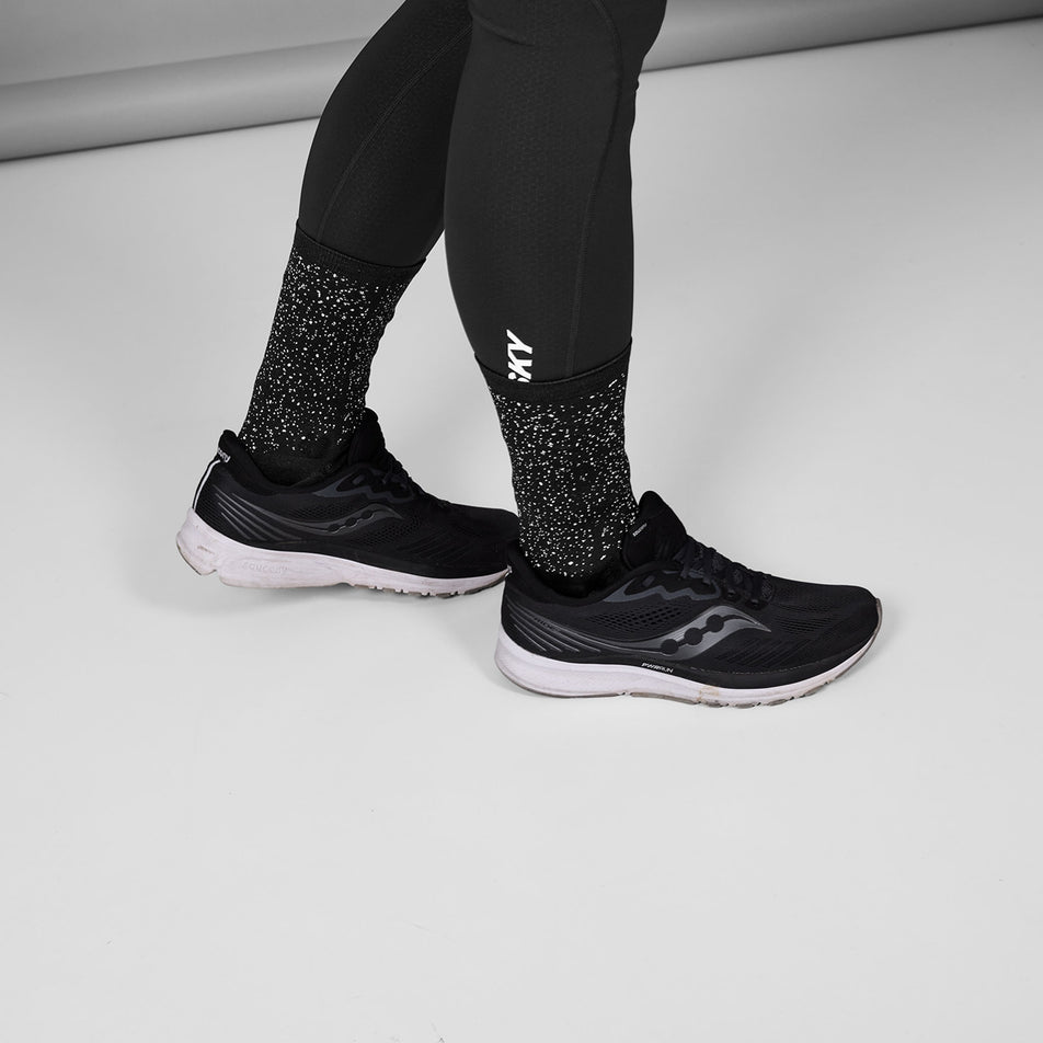 A model wearing a pair of SAYSKY Unisex Combat Reflective High Socks in the Black colourway. (8788287291554)