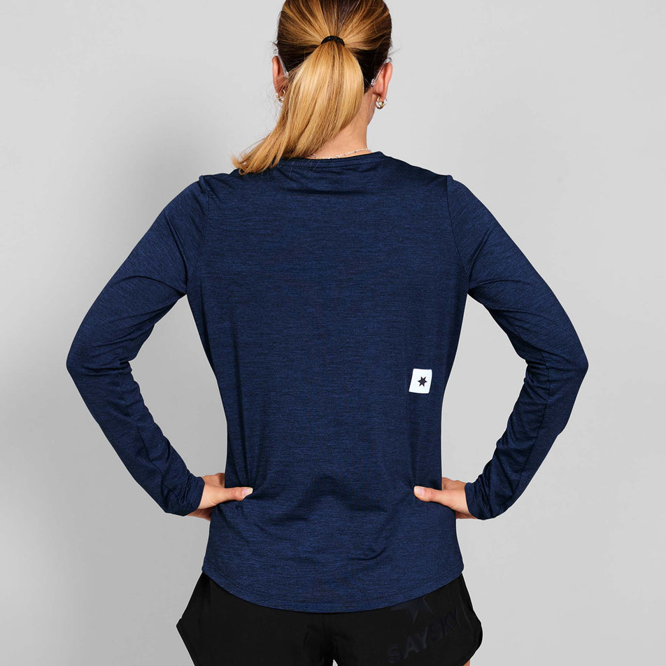 Back view of a model wearing the SAYSKY Women's Clean Pace Long Sleeve in the Blue colourway. (8731654062242)