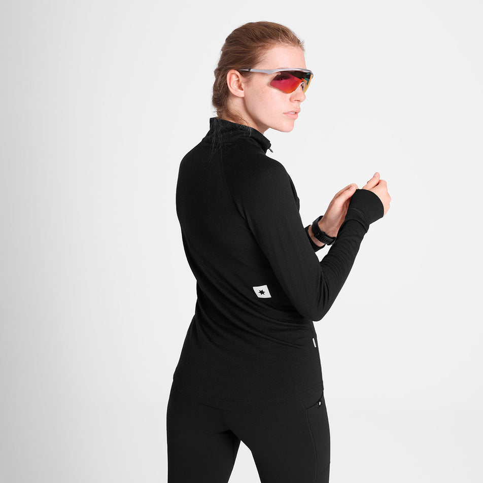 Back view of a model wearing the SAYSKY Women's Merino 165 Base 1/2 Zip Long Sleeve in the Black colourway.