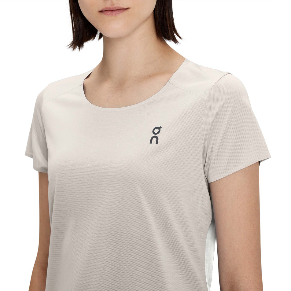 Close-up front view of a model wearing a women's On Performance T in the pearl and undyed white colour (7763908853922)