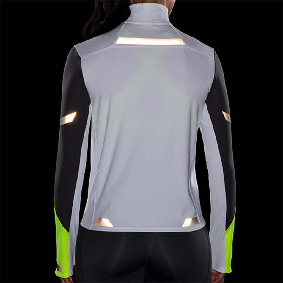 Reflective back view of Brooks Women's Run Visible 1/2 Zip in white (7596658196642)