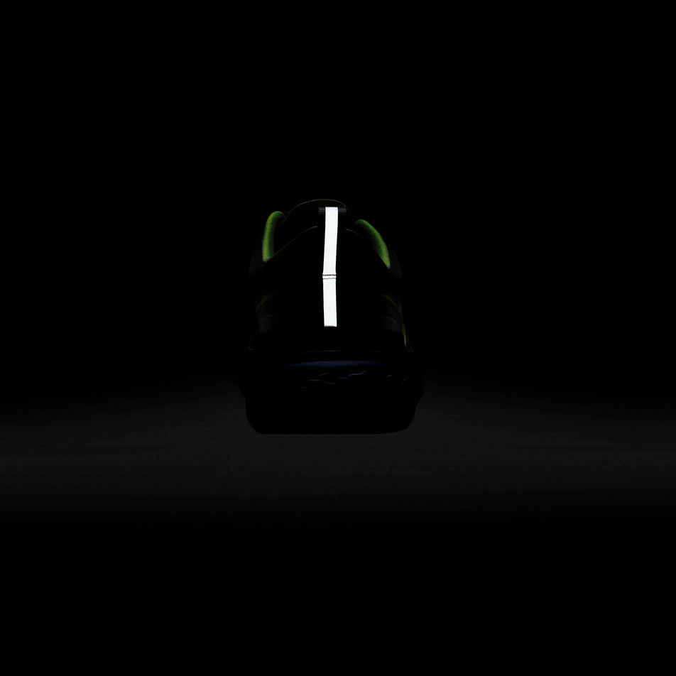 The reflective heel tab on a Nike React Miler 2 shoe glowing in a dark surrounding (6899681722530)
