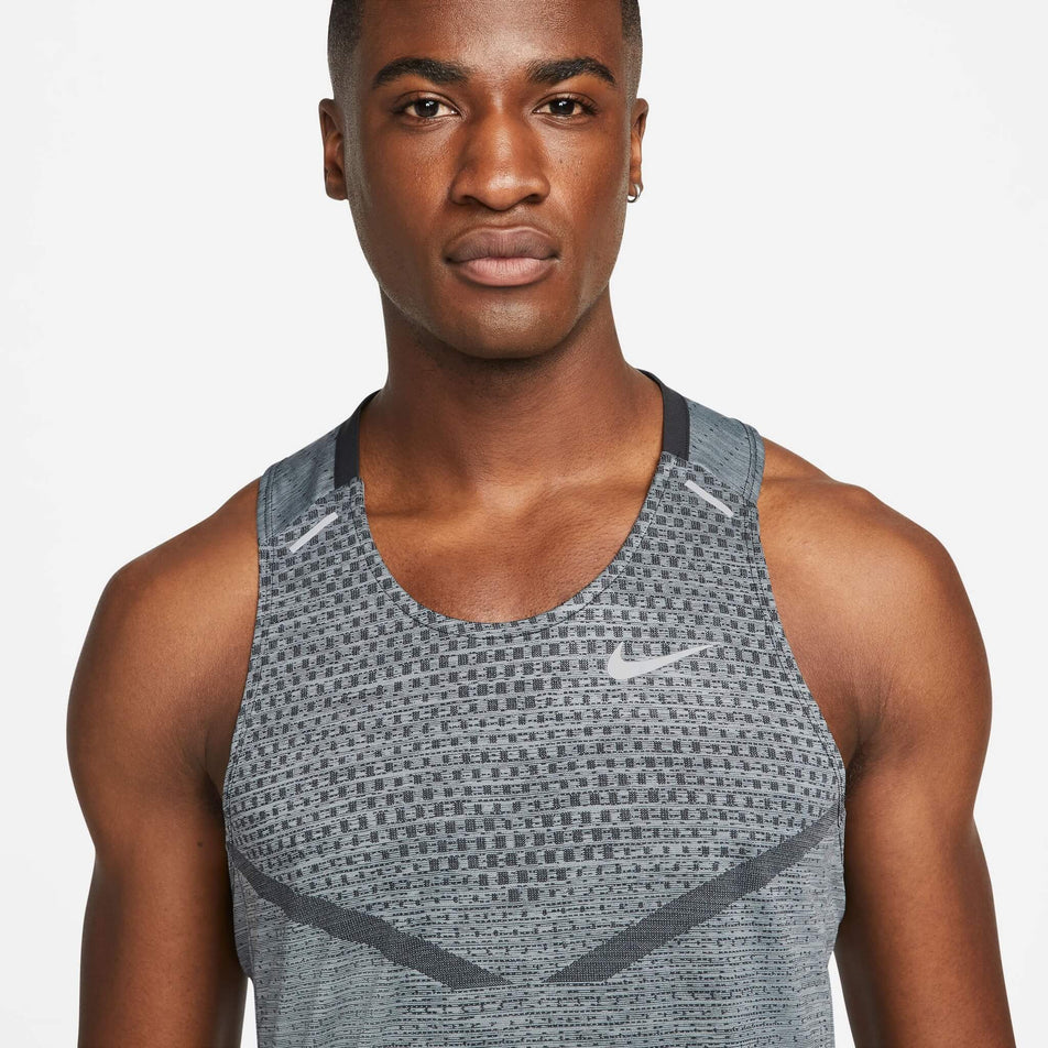 Front view of a model wearing a Nike Men's Dri-FIT ADV Techknit Ultra Running Tank - close-up of the chest section (7876647288994)