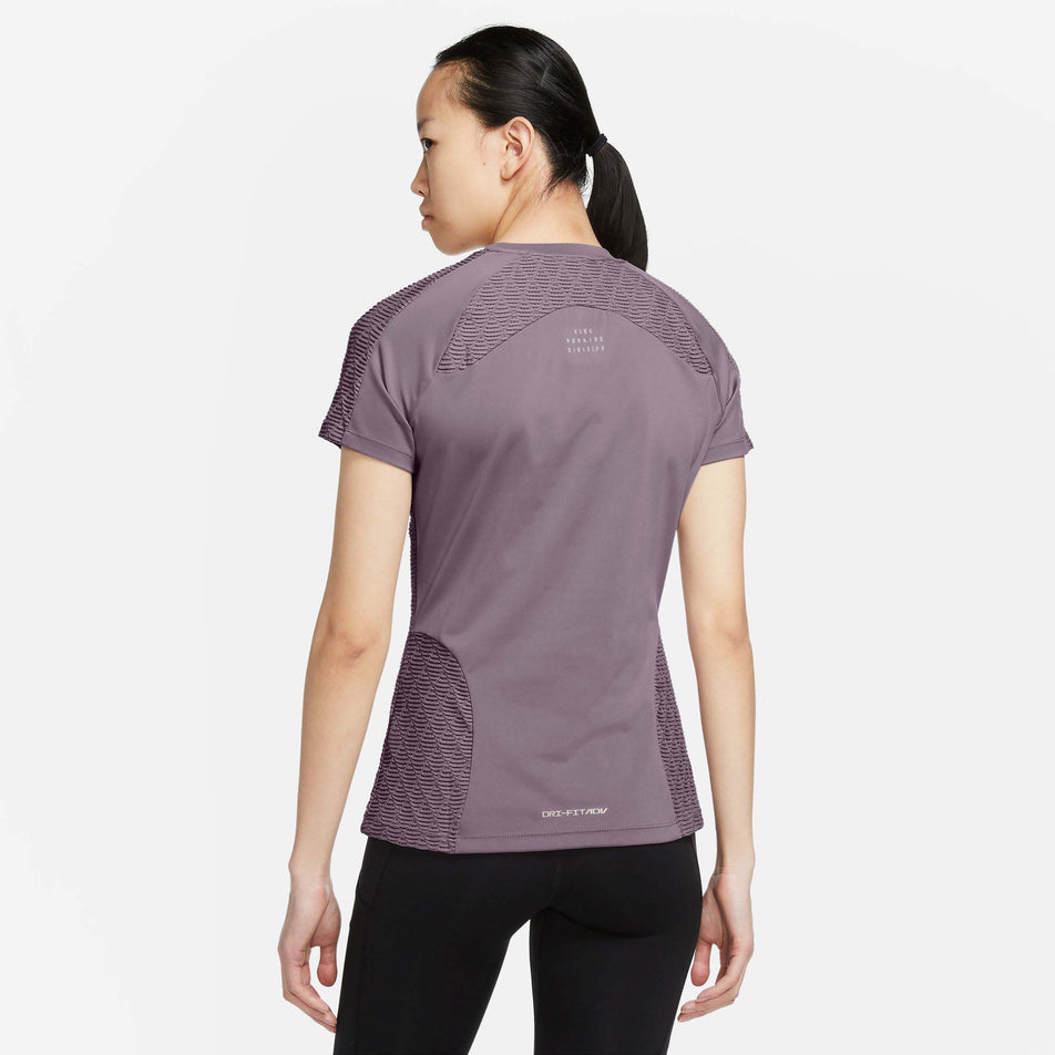 Rear view of Nike Women's Dri-Fit ADV Run DVN SS Top in purple (7683344826530)
